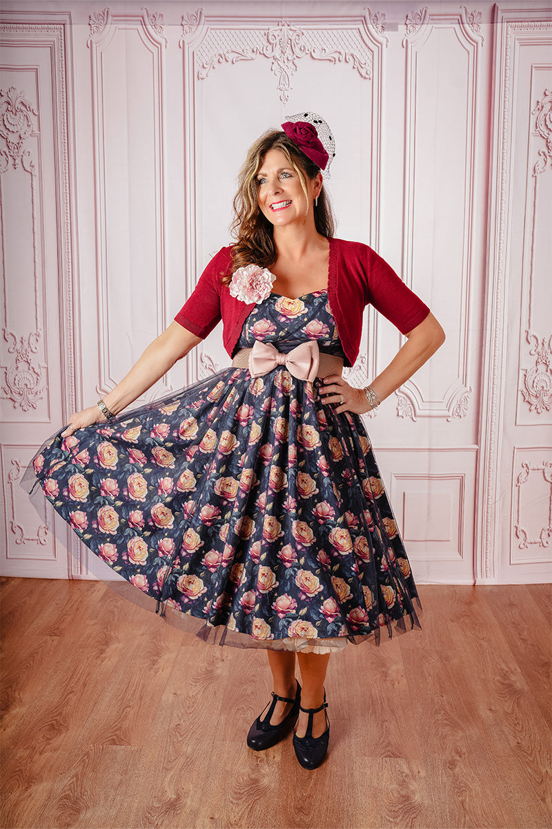 Burgundy Briony Bolero on Model Paired with Print Dress and Fascinator