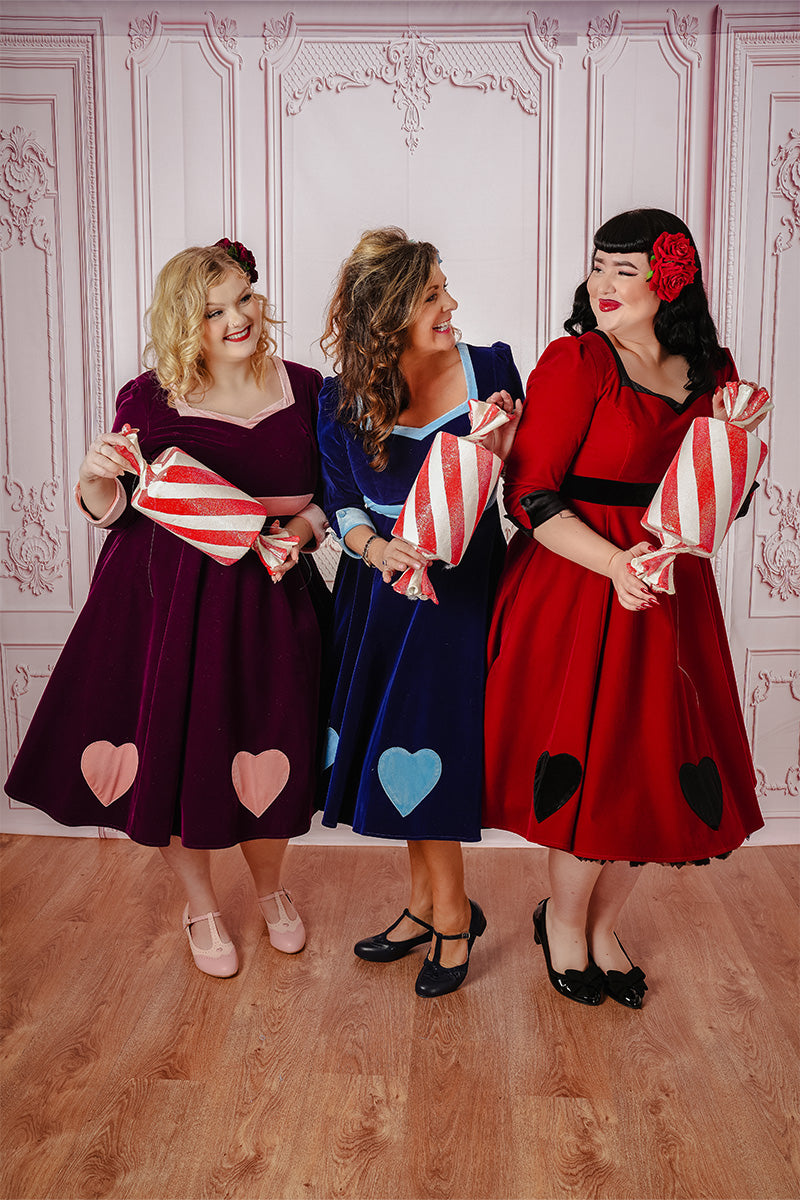 Cheshire Swing Dress Full Body Models in Different Colour Variations Holding Large Candy Sweets