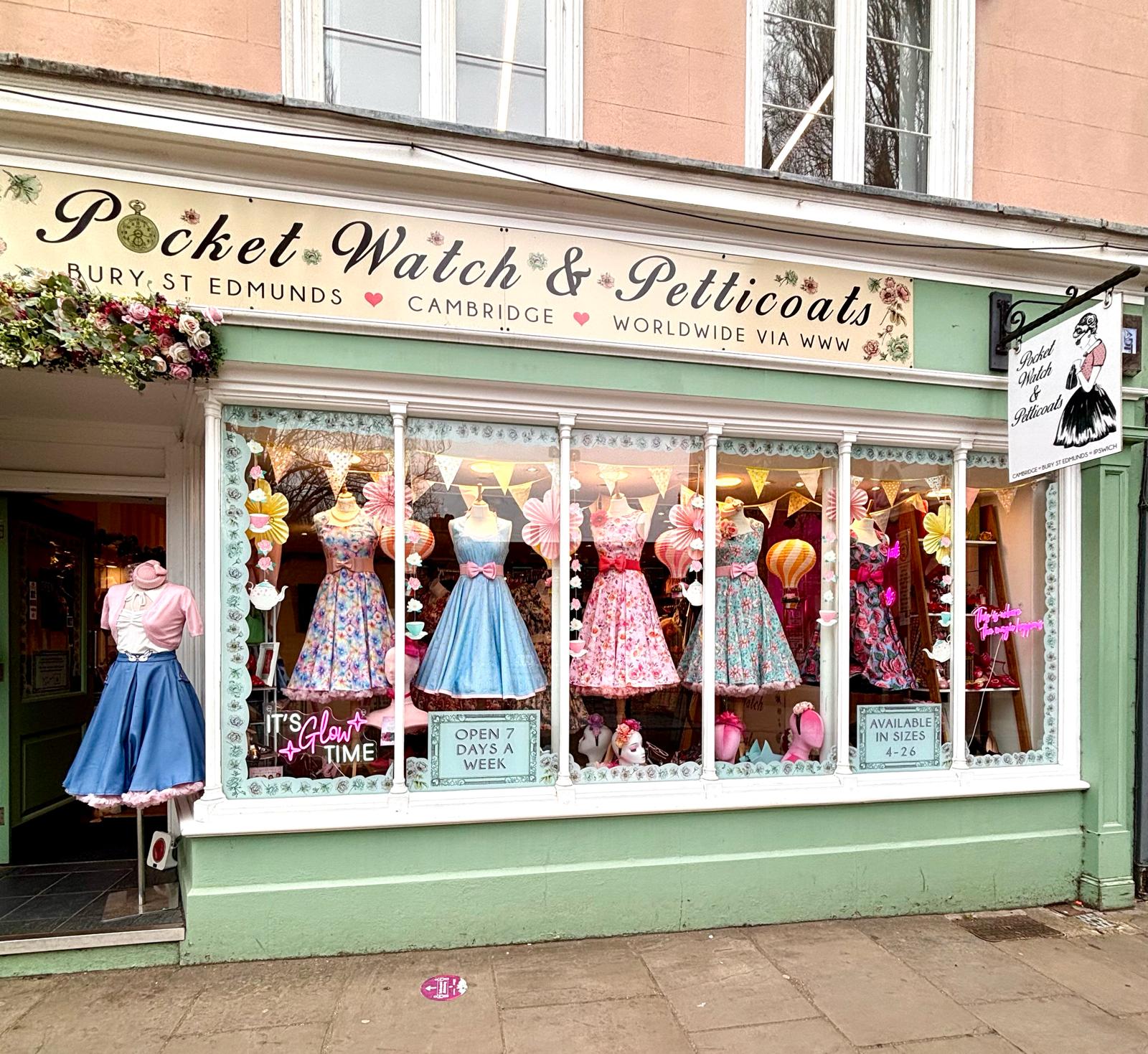 Exterior shot of the front of the store in Cambrigdge. Vintage dresses in windows.